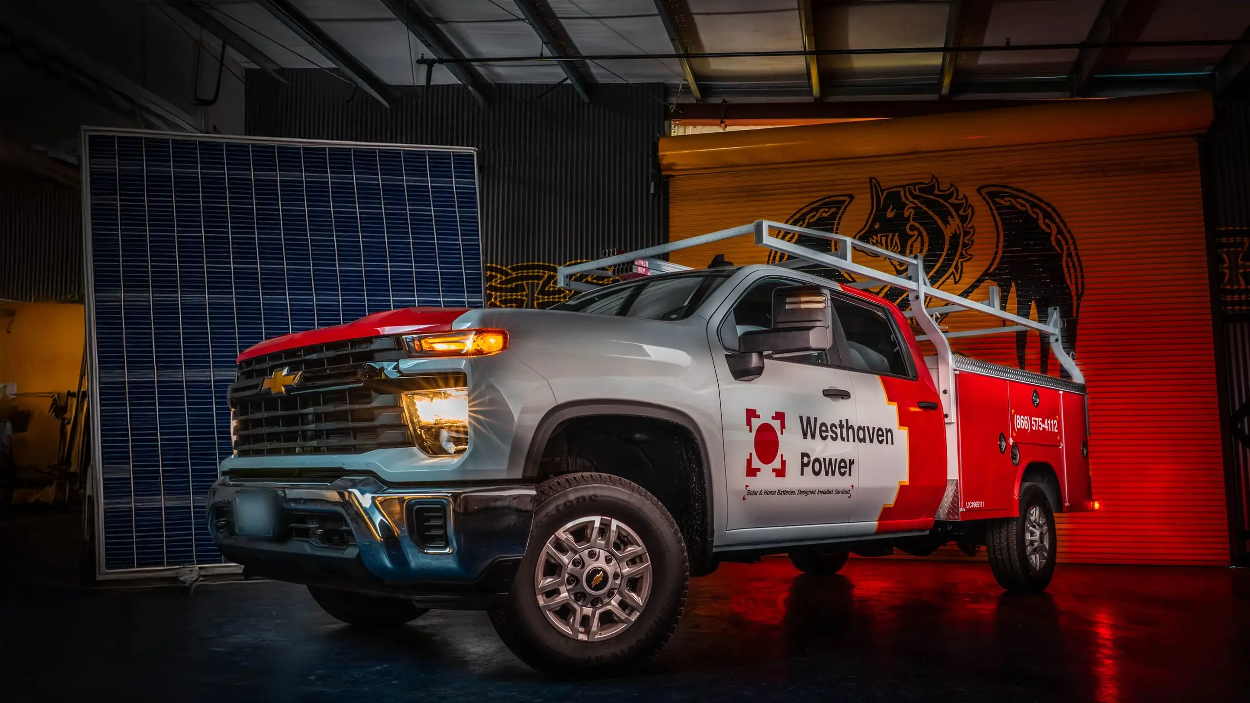 A wrapped Westhaven Power truck and solar panel inside the company warehouse.